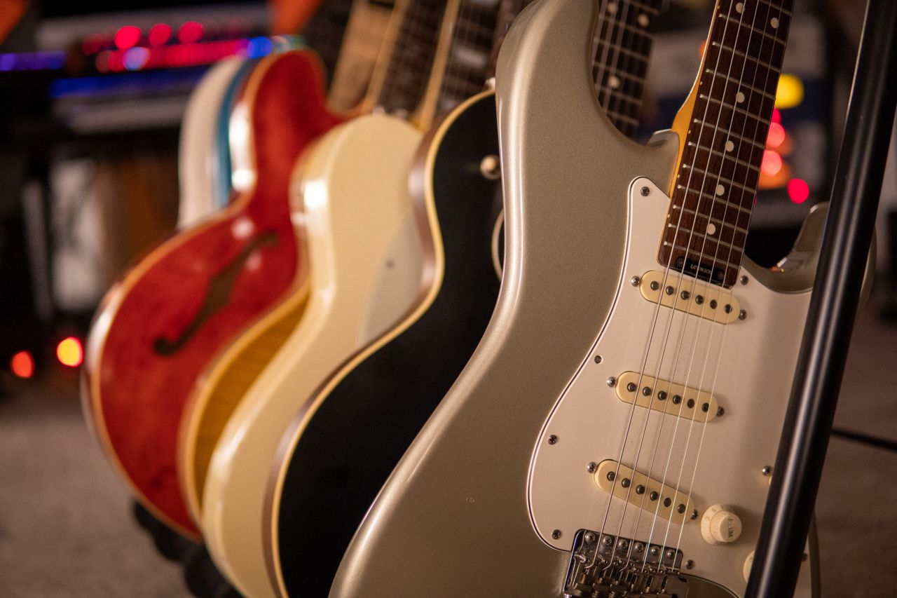 Row of electric guitars with a focus on elegant design and strings.